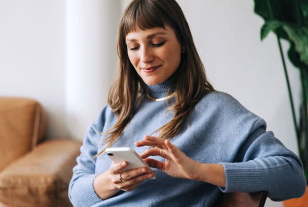 woman looking at here cell phone